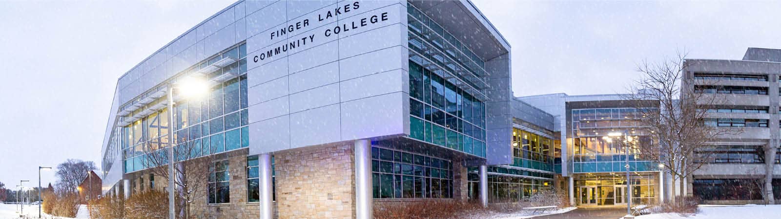 Winter scene of Finger Lakes Community College main campus building with snow.